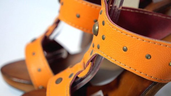 YouTube video production. Photo of a pair of orange leather ladies summer shoes