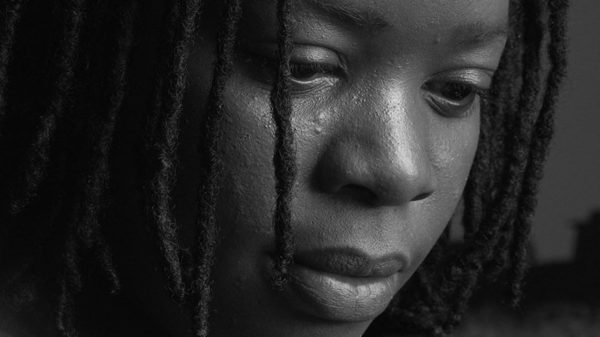Charity documentary video production. Black and white still image of Speech Debelle.