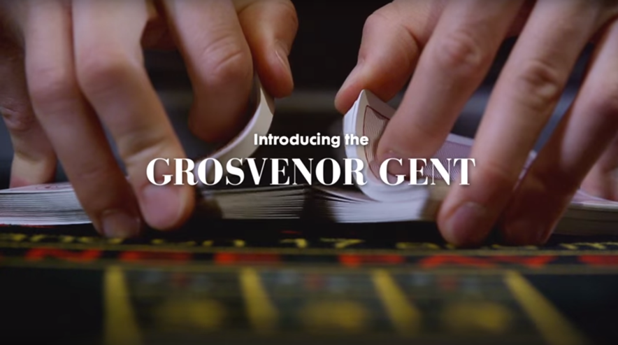 Agency video editor. Background image of two hands flicking cards together with title text overlaid