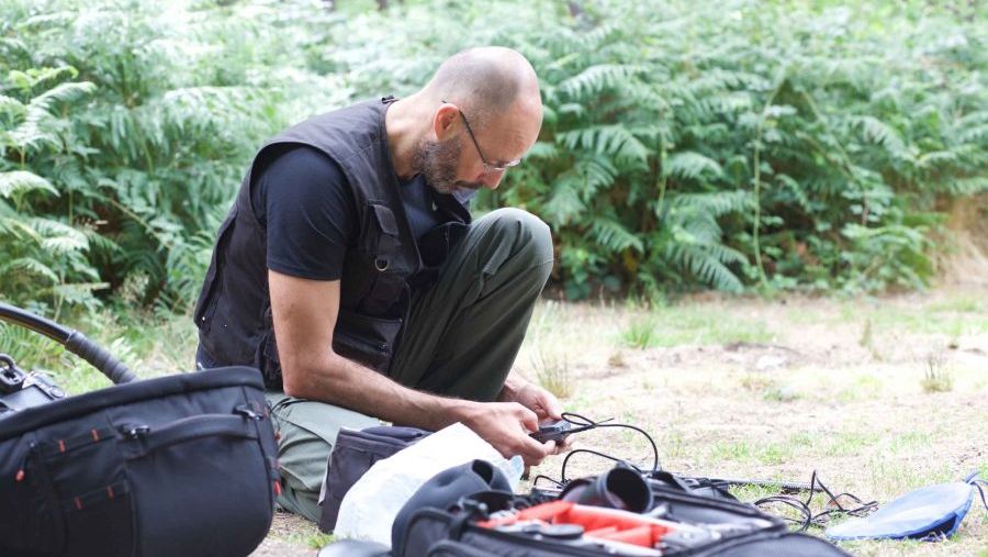 Julian-Langham-London-videographer-working-in-the-field-prepping-radio-microphones