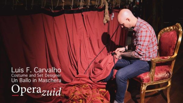 Video production Luis F. Carvalho sewing a red stage curtain