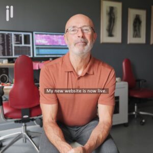 1:1 social reels showing Julian Langham, videographer, sitting in front of his workstation looking at the camera.