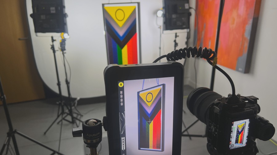 Filmmaking career advice showing studio setup, lights, camera, monitor and the subject a pride progress flag in fused glass