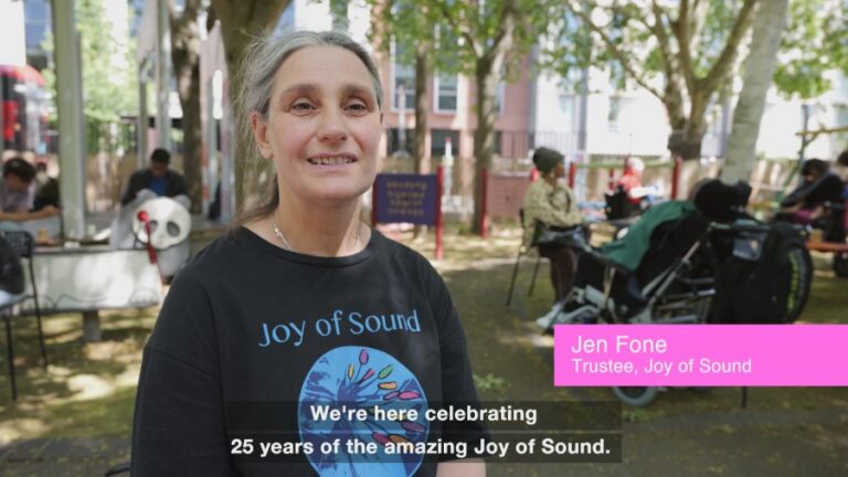 Documenting an anniversary showing a mid shot of Jen Fone JoS trustee with name text overlay and subtitles.