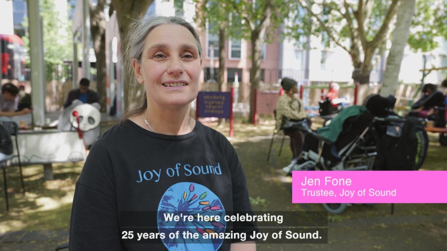 Documenting an anniversary showing a mid shot of Jen Fone JoS trustee with name text overlay and subtitles.