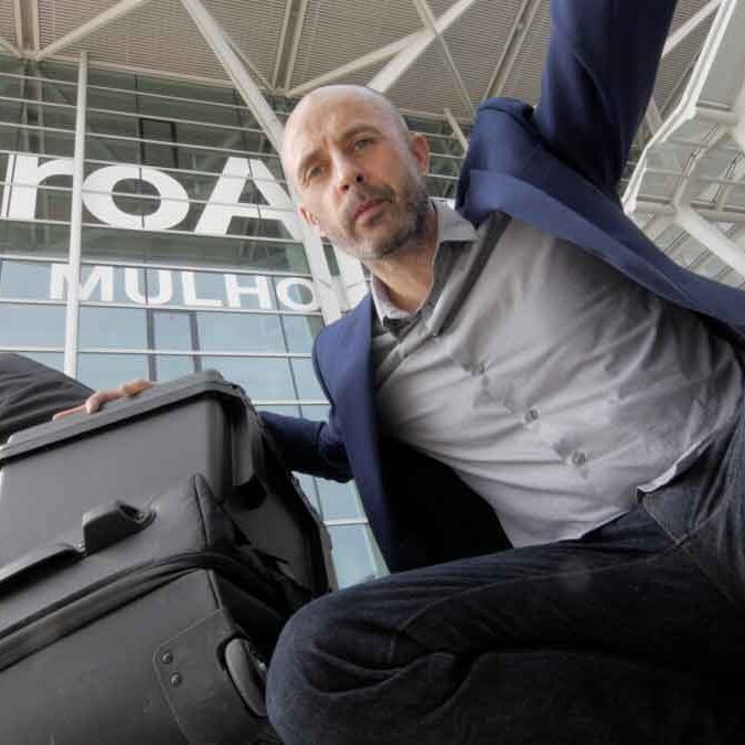 Videographer Julian Langham with his filming kit loaded on a trolley outside Basel Mulhouse airport